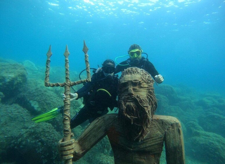 A diver with a trident and another diver in a diver's suit. 5