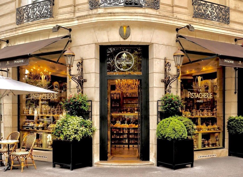 A storefront with the sign 'Pistachierie Paris' and a chandelier visible through the window. 4