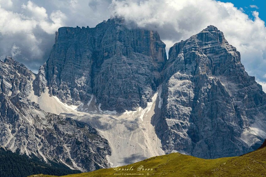 A rugged mountain range with sharp peaks and a valley below. 1