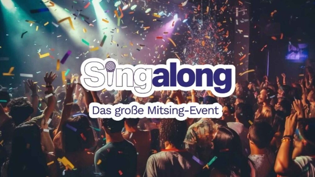A concert with confetti falling and a crowd of people raising their hands. 1