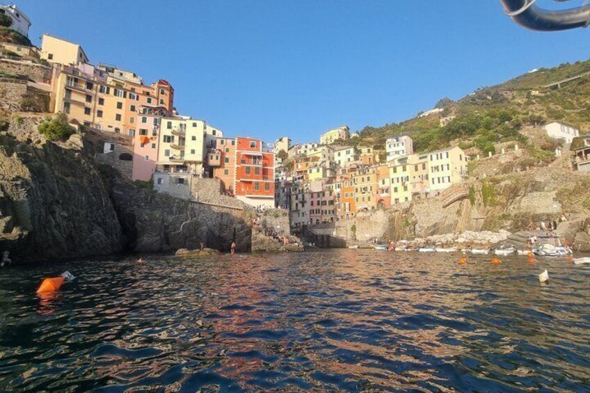 A coastal town with colorful buildings, calm water, and boats. 5