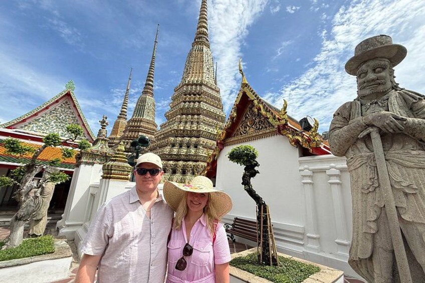 A temple with multiple spires, a statue, and a well-maintained garden. 5