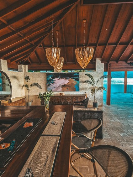 A wooden ceiling, a bar area, and a mural of a beach scene. 2