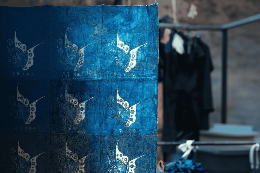 A blue fabric with white butterfly patterns and numbers. 1