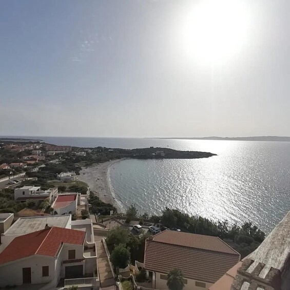 A coastal town with buildings, a beach, and the sea. 1