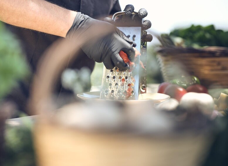 A person grating cheese over a plate. 4