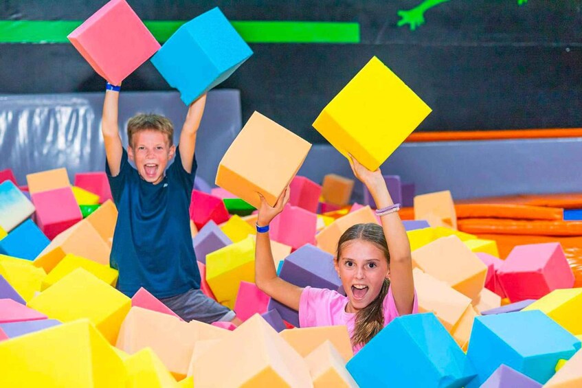 Children playing in a foam pit with colorful blocks. 3