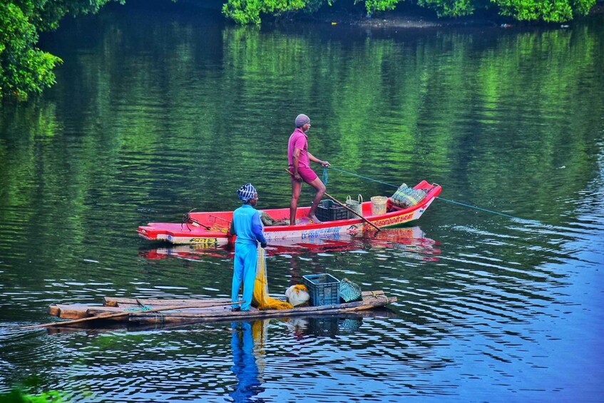 Two people on a small boat in a calm river, surrounded by greenery. 5