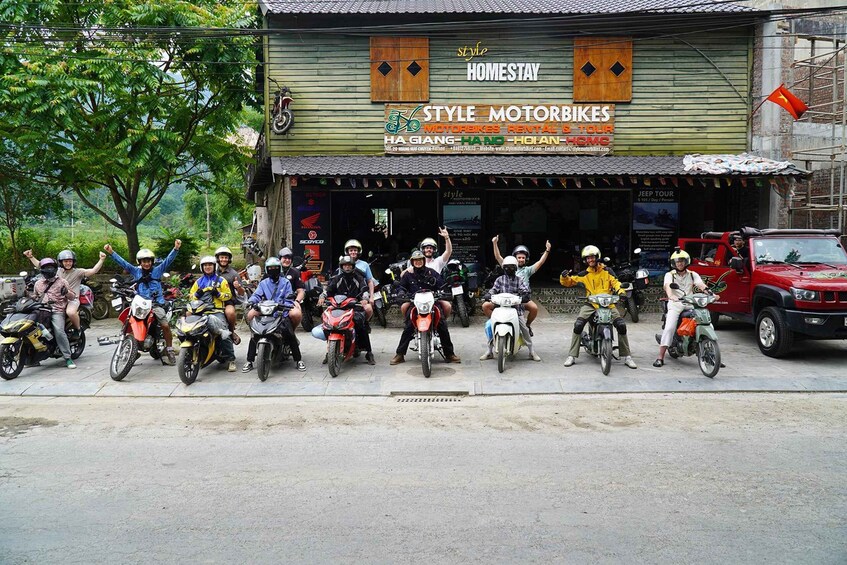 A group of motorcyclists posing in front of a motorbike rental shop named 'Style Motorbikes.' 1