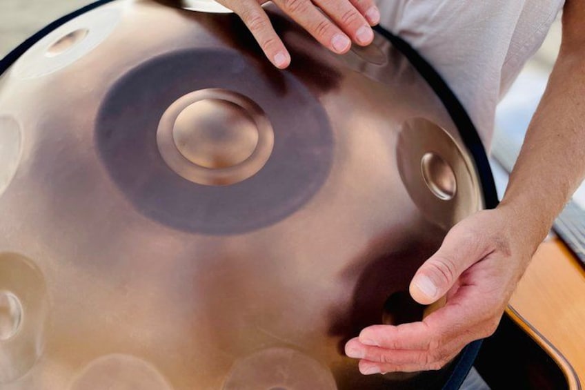 A person holding a handpan. 4