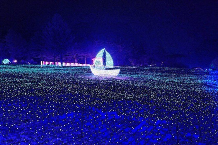 A lighted sailboat on a field of blue lights. 5
