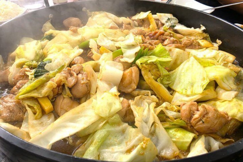 A stir-fry dish with vegetables and meat in a pan. 4