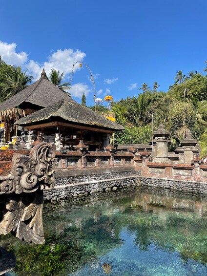 A traditional Balinese temple with a clear pool in front. 2