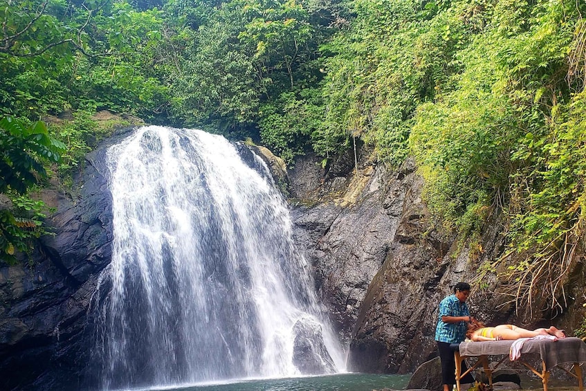 A waterfall, a massage therapy session, and lush greenery. 2