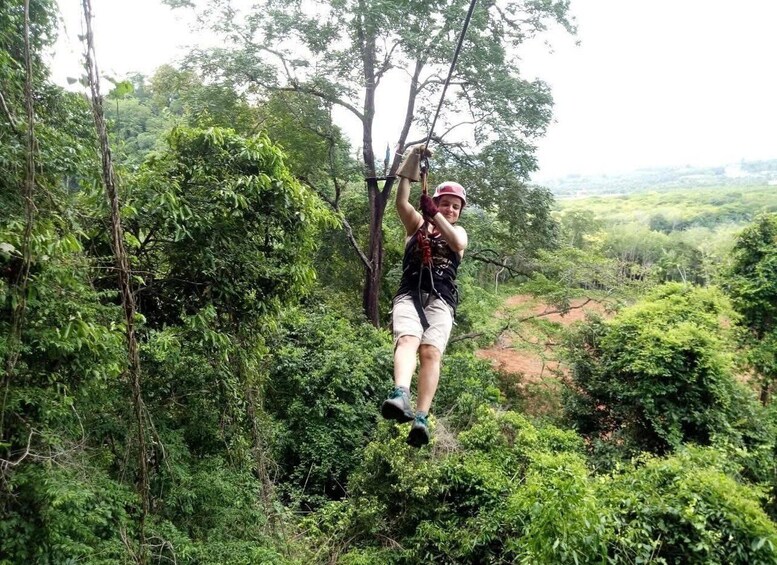 A person zip-lining through a dense forest. 5