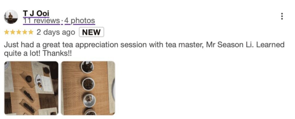 A wooden board with tea leaves and a cup. 2