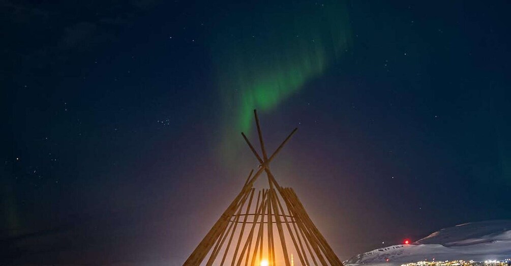 A teepee under a night sky with the aurora borealis. 2