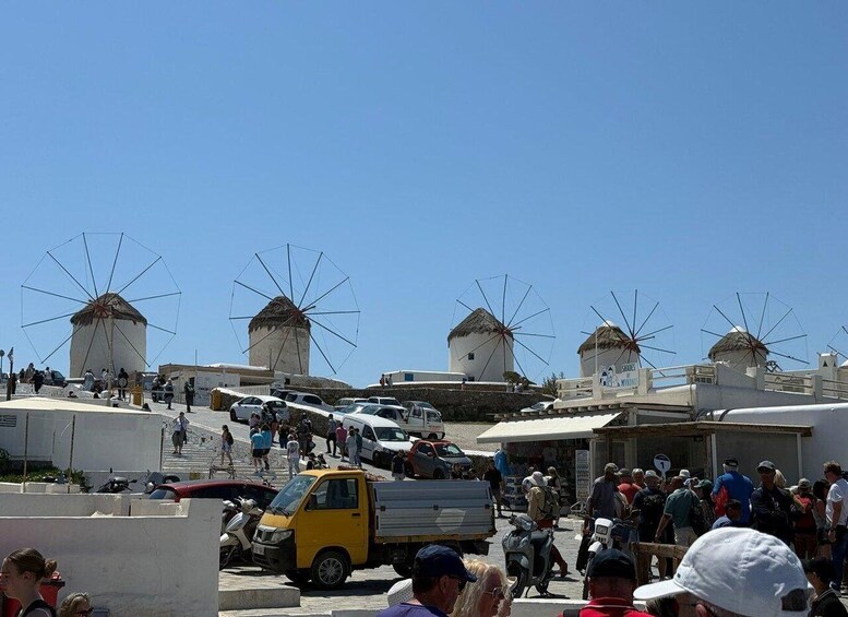 A busy street with windmills and parked cars. 2