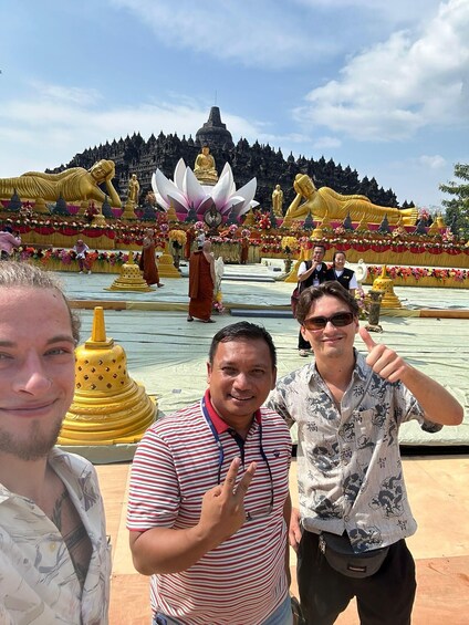 A temple with golden statues and a lotus pond. 2