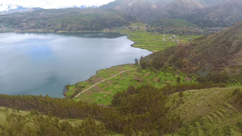 A lake surrounded by terraced fields and mountains. 5