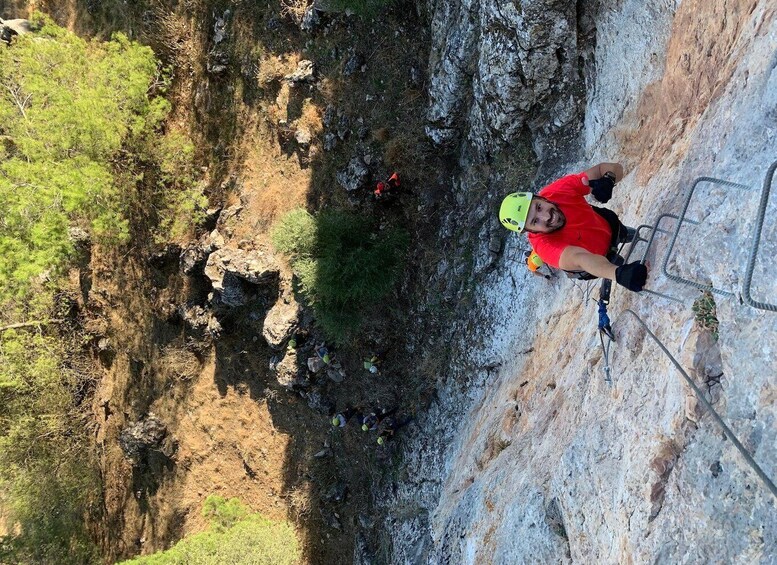 A person rappelling down a rocky cliffside. 5