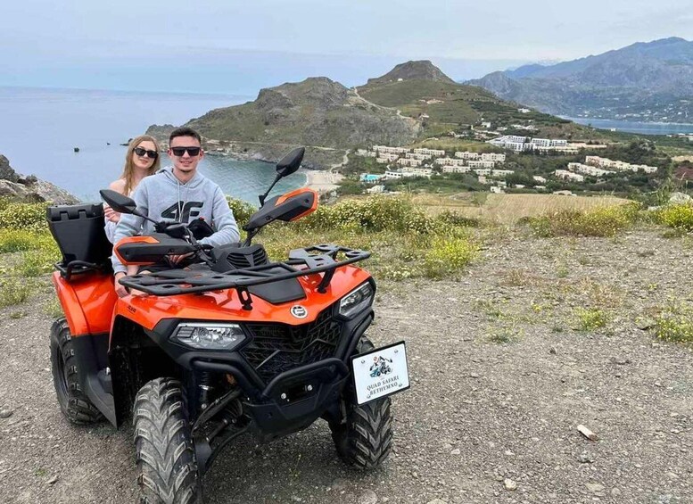 A quad safari vehicle parked on a dirt path with a coastal landscape in the background. 3