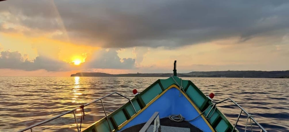 A boat on calm water during sunset with a clear sky. 1