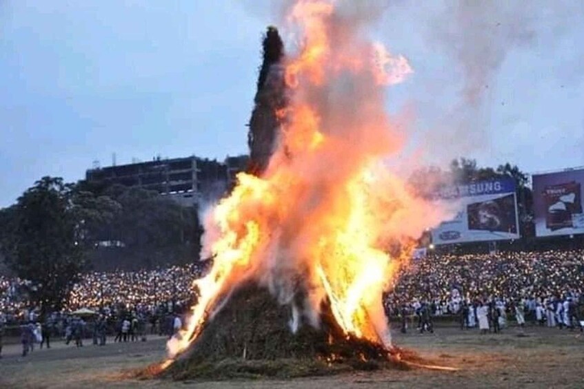 A large fire with a crowd of people in the background. 2