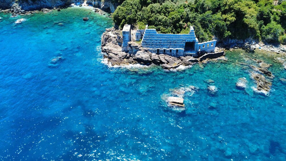 A coastal structure with clear blue waters and rocky terrain. 4
