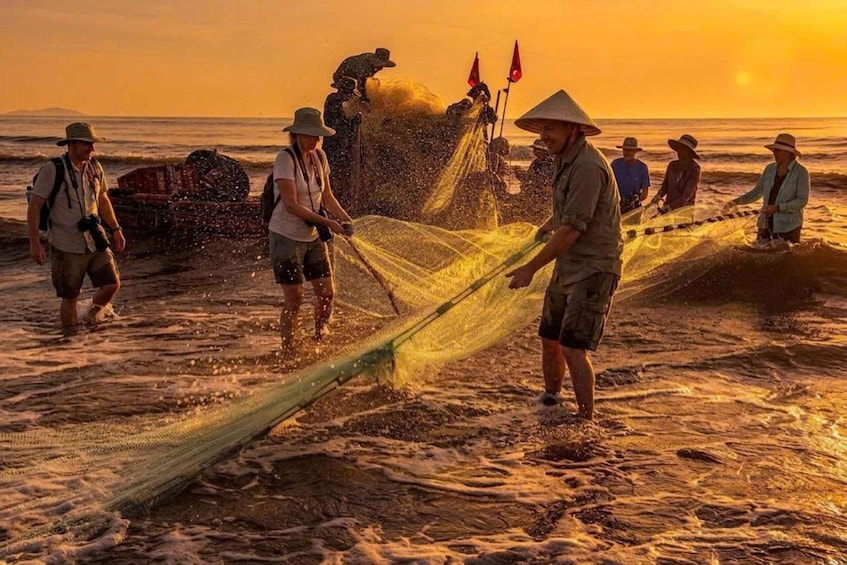 People fishing at the beach during sunset. 1