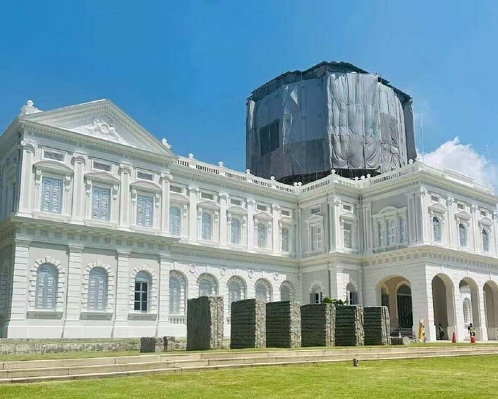 A large white building with a covered structure on top. 2