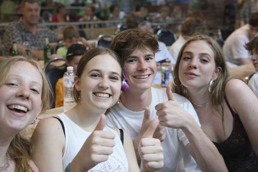 A group of people sitting at a table in a public indoor space. 3