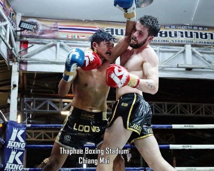 Two boxers in a ring at Thaphae Boxing Stadium in Chiang Mai. 1