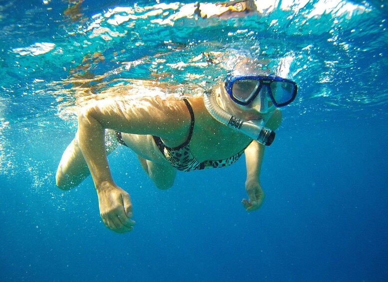 A person snorkeling underwater. 1
