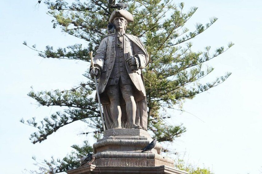 A statue of a historical figure on a pedestal, surrounded by trees. 2