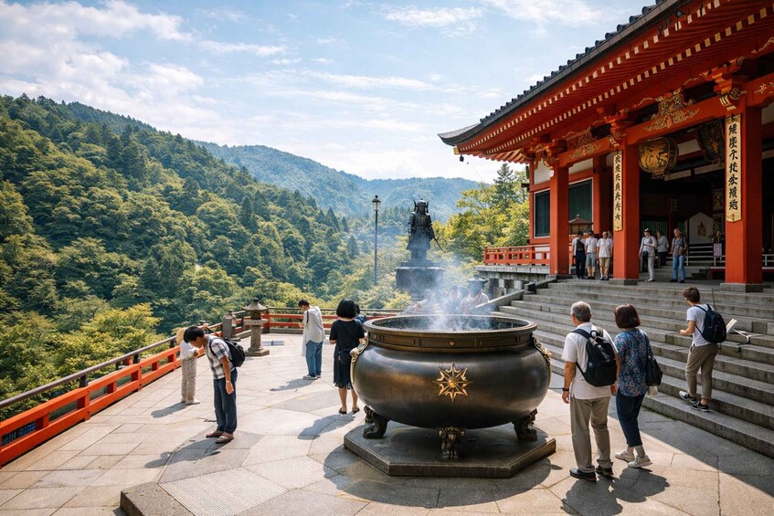 A traditional Japanese temple with a large bronze cauldron emitting steam, surrounded by lush green mountains. 2