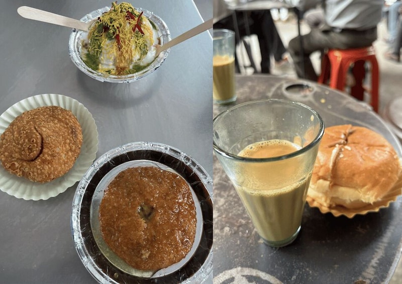 A table with food items including a bun, a bowl of chutney, a glass of milk, and a bowl of noodles. 5