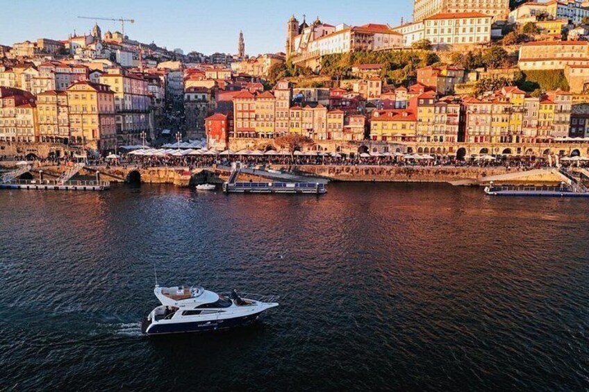 A river with a boat, a bridge, and a cityscape with buildings. 4