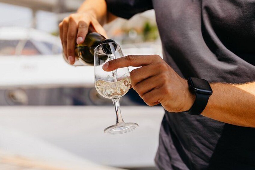 A person pouring a liquid from a bottle into a glass. 5
