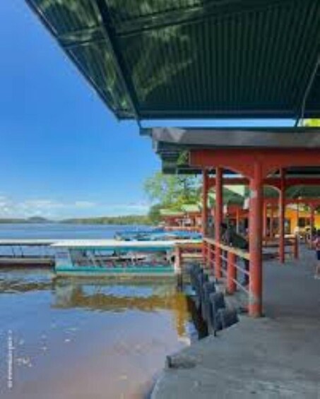 A covered pier with a view of the water and boats. 3