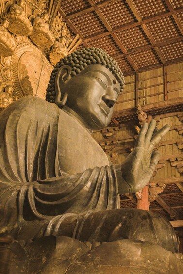 A large Buddha statue with intricate carvings and a traditional wooden ceiling. 2