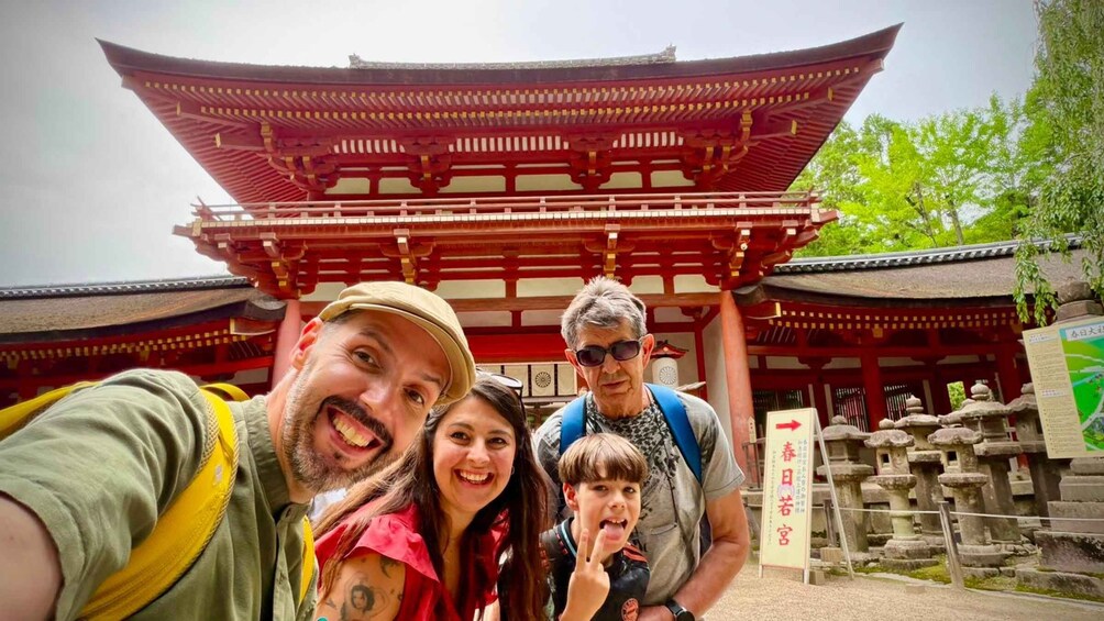 A traditional Japanese gate with a red roof and wooden pillars. 3