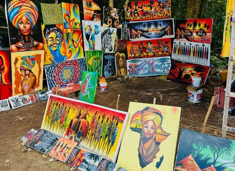 A variety of colorful paintings displayed outdoors, likely at an art fair or market. 5