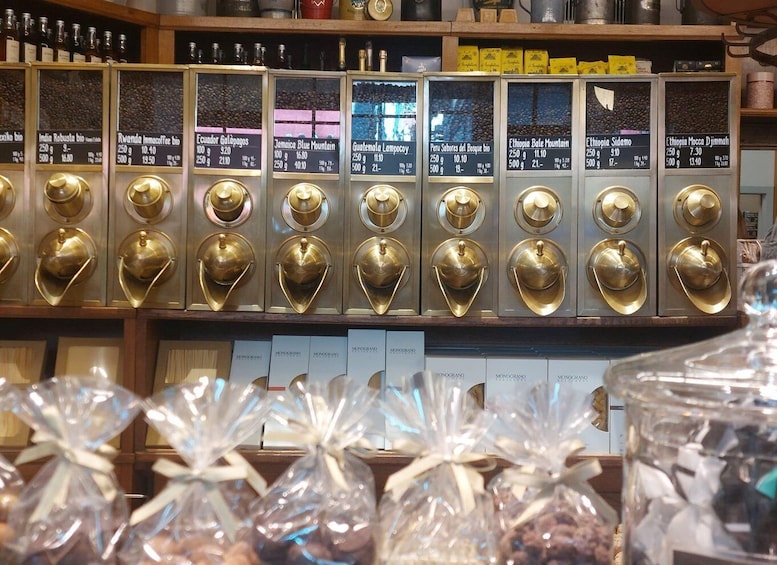 A coffee shop with various coffee beans displayed in glass containers and labeled with origin names. 3