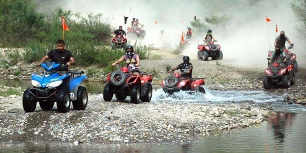 Off-road vehicles crossing a shallow water stream in a rugged terrain. 2