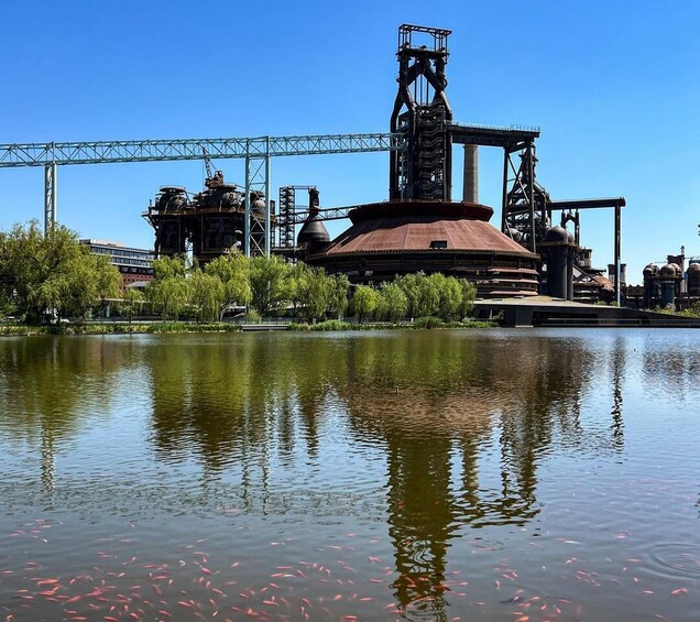 A river with industrial structures and a bridge in the background. 3