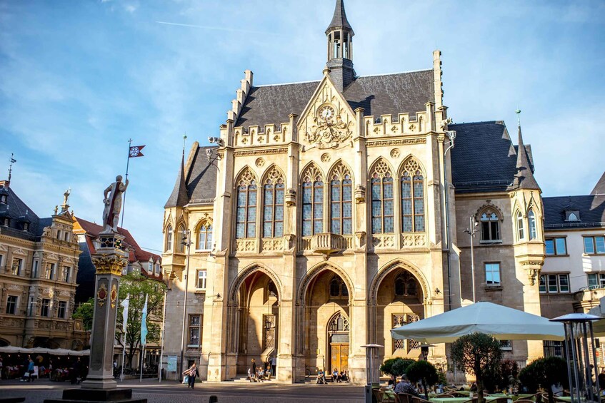 A historic building with pointed arches and a clock tower. 4