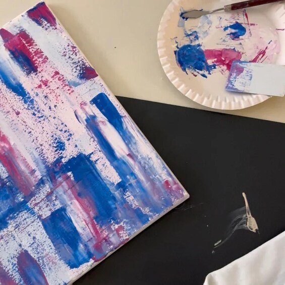 A painting with blue and red streaks on a black surface. 3