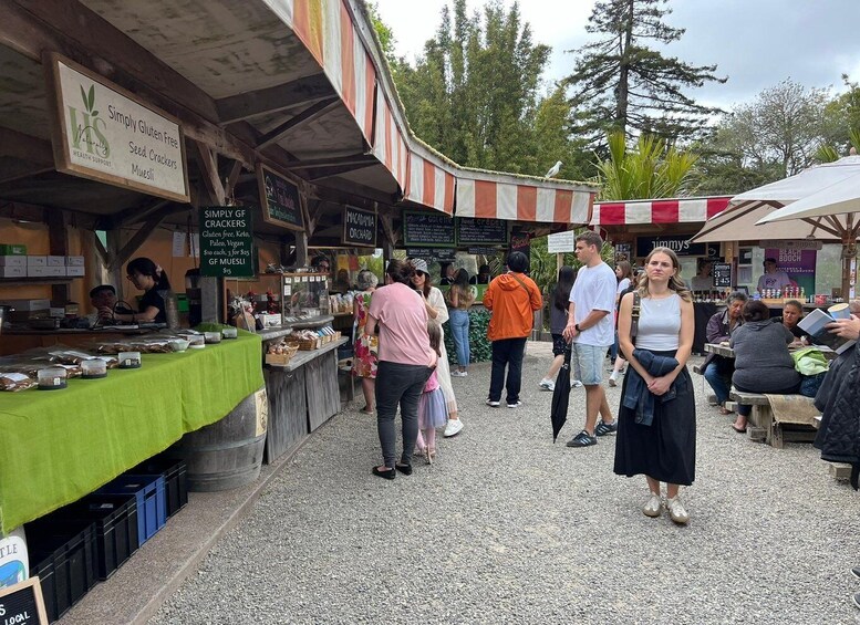 A market with various stalls, including one labeled 'Simply Gluten Free Seed Crackers.' 5