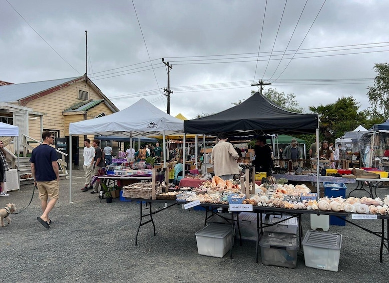 An outdoor market with various stalls selling goods, including seafood and other items. 3
